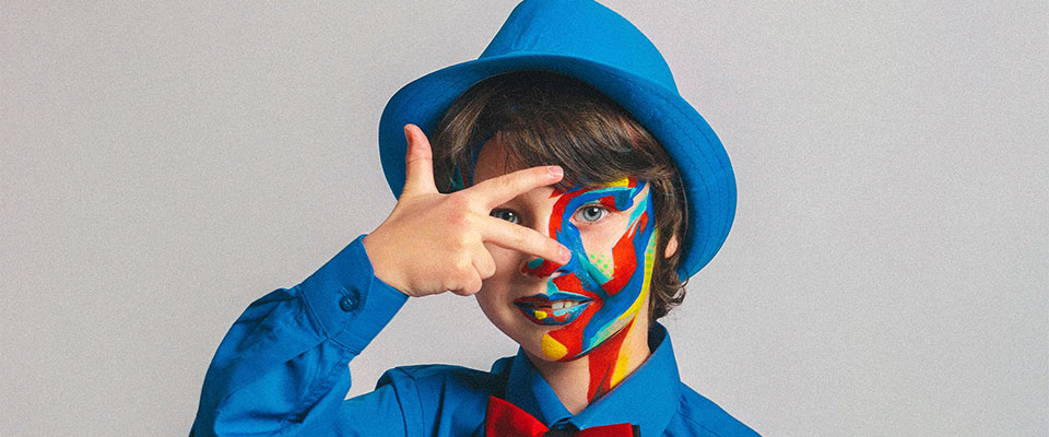 child in face paint and blue suite